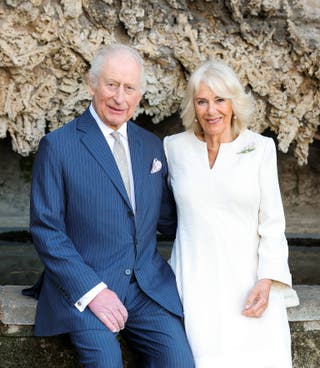 The Queen is wearing a white and beige coat dress by Anna Valentine and a Lily of the valley brooch in the images (Chris Jackson/Buckingham Palace)